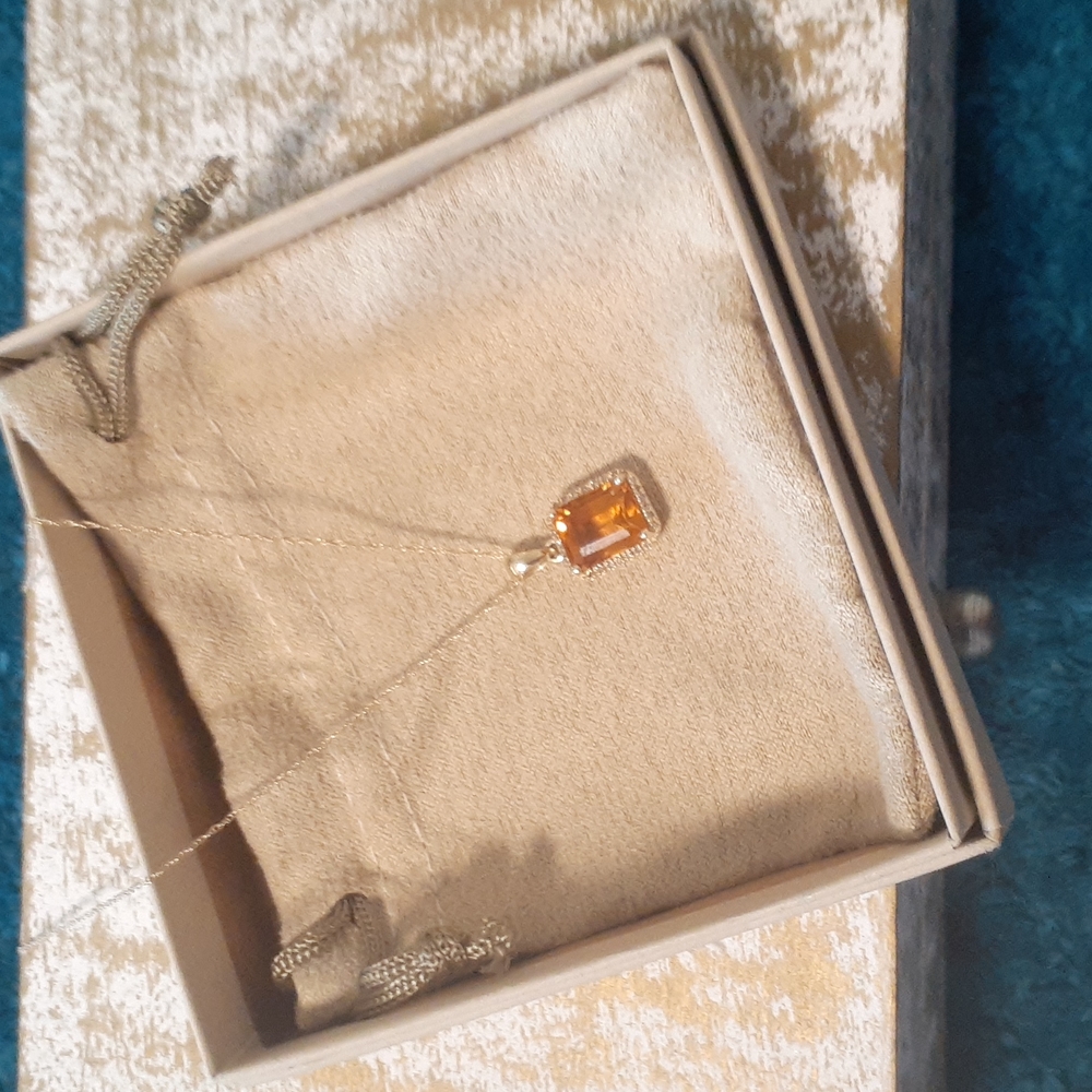 Emerald cut citrine stone with sm. Diamond chips.